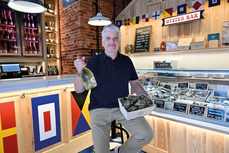 Barra de El Puertito Bilbao con una caja de ostras y una botella de vino blanco